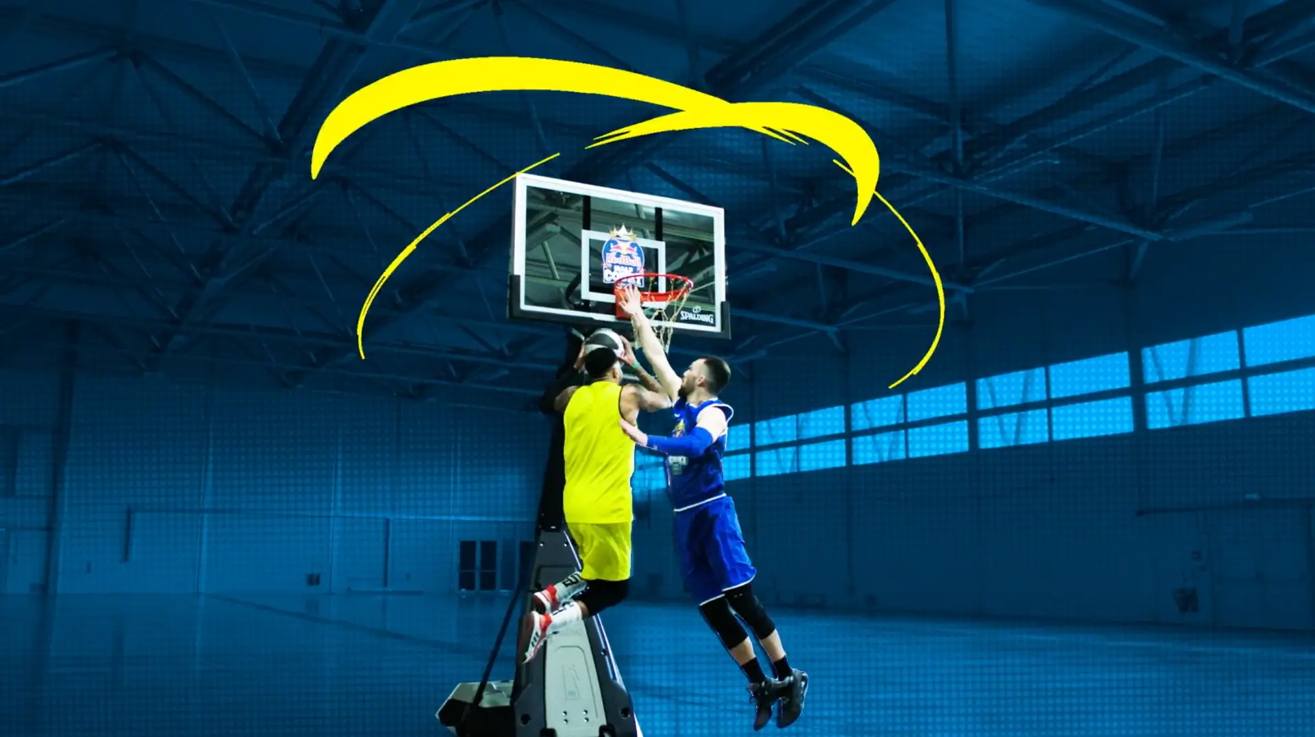 Player jumping to score at the basket with a graphic visual-effects flourish in the Red Bull campaign